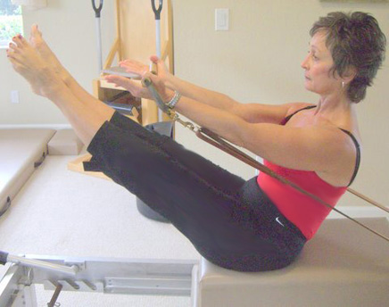 Pilates Teaser exercise on reformer apparatus